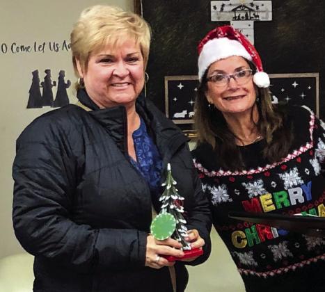 Coming in third in the tree decorating contest with 86 votes, Carol Ann Daves, accepts the honor for her business, Carol Ann’s Flower’s &amp;amp; Gifts, from Karen Caldwell, chamber president.