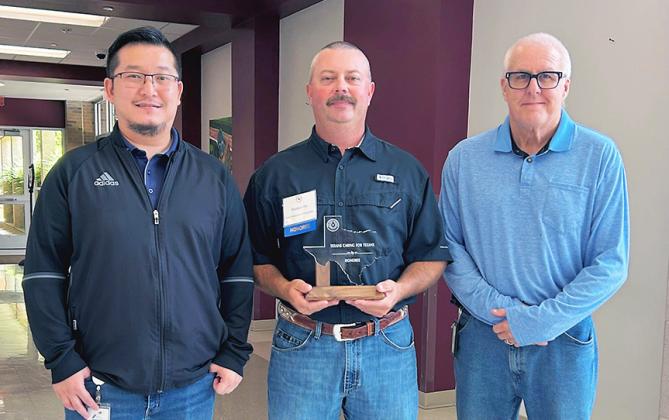 Matt Orr, center, TxDOT Environmental Project Planner for the Childress District, received a Texans Caring for Texans award at the annual ceremony in Canyon on Thursday, August 6. Lin Xie, Director of TP&amp;D, left, and Darwin Lankford, Childress District Engineer, are pictured with Orr. TXDOT PHOTO