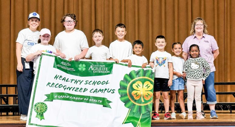 Childress Elementary School is recognized as a Healthy School Recognized Campus — a designation awarded to the school by the Texas A&amp;amp;M AgriLife Extension Service. From left: Childress Elementary School Principal Tracey Blake, Karter Sherwood, McCrae Detwiler, Dawson Adcock, Evan Rodriguez, Cruze Rodriguez, Kopper Sherwood, Taylinn Brown, Hannah Harris, Texas A&amp;amp;M AgriLife Extension Service of Childress County Family and Community Health Agent Sandra Moody. SHAYLEY ELLIOTT