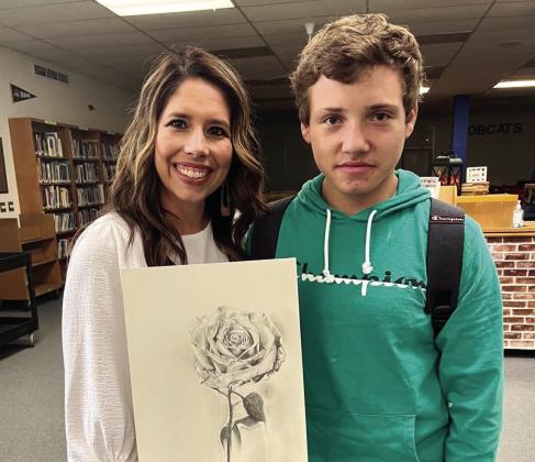 Childress High School (CHS) art student Landon Senn gifts CHS teacher Janet Pierce artwork featuring her “word of the year.” Photo Courtesy of Childress High School