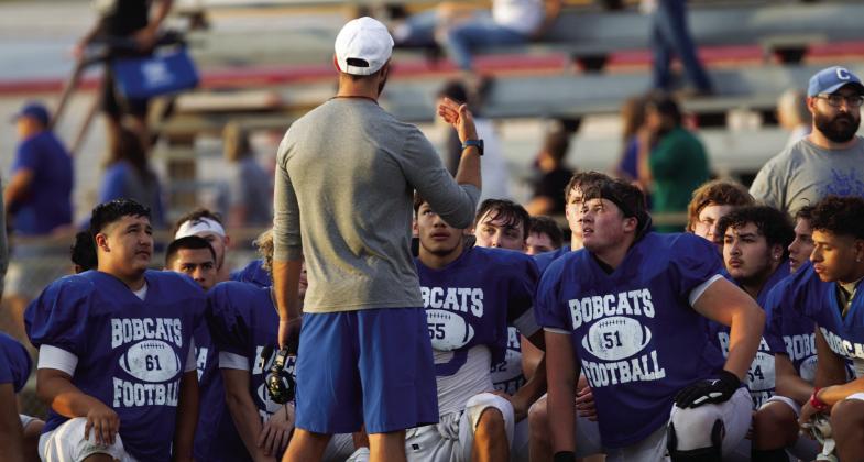 Childress Athletic Director and head football coach Bo Helm speaks to the Bobcats following the scrimmage against the Clarendon Broncos Friday, Aug. 19 in Clarendon.