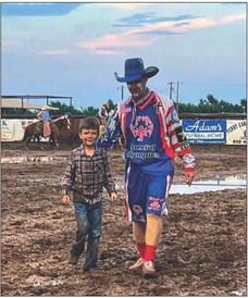 Caleb Peters takes the Saturday night mutton bustin’ championship during the 2022 Wellington Fourth of July Rodeo. Almost an inch of rain delayed the final performance of the rodeo. Goobie the Clown accompanied Caleb back to the gate. Courtesy Photo