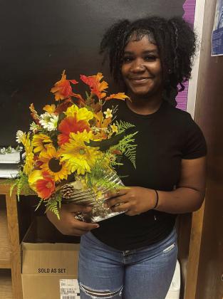 Floral design students upcycle tin cans