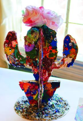Constructed using cardboard and paint scraps, Selah Smith creates a cactus sculpture. Art by Selah Smith