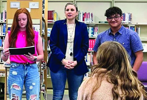 Wellington Junior High School language arts teacher Mikki Lewis introduces Bailey Page and Christopher Reyes.