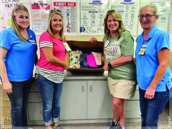 Walmart Supercenter donates clothing, which will be used when children need a change of clothes, to the Childress Elementary School nurse’s office Tuesday, Sept. 13. From left, Walmart employees Jamie Aguirre and Misty Willis, Childress Elementary School Nurse Cathy Hardin, and Walmart employee Mendi Walker. Photo Courtesy of Walmart