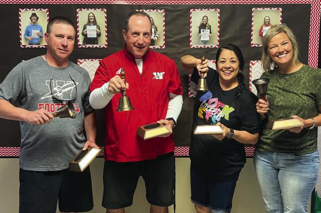 Jeff Anderson, left, Joe Jones, Maria Granados and Amy Inman accept brass bell tokens for 15-year service awards.
