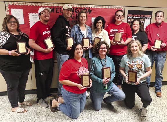 Eleven members of the Wellington ISD staff accept walnut plaque awards for five years of service. Front row, from left: Denise Garcia, Brandi Weinette, Mikki Lewis. Back row, from left: Brittni Bohannon, Quenton Patterson, Greg Proffitt, Heather Proffitt, Lesa Thornberry, Shelby Morris, Jill Dugan, Edward Beck.