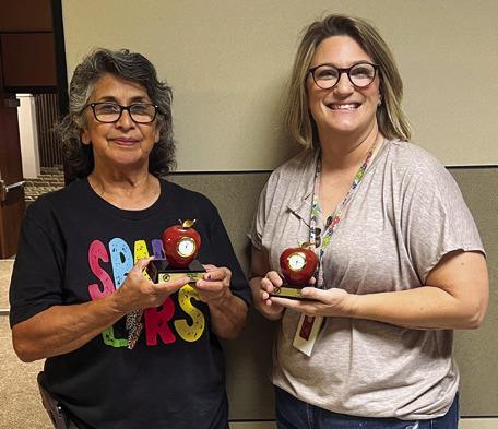 Irma Thomas, left, and Lana Tillman mark 10 years of service to Wellington Independent School District, displaying their red, apple clock tokens.