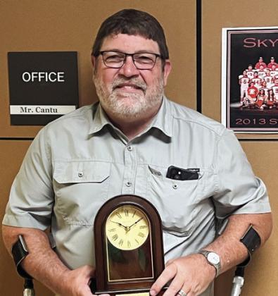 Del Davis accepts a pendulum clock in honor of his 30 years of service to Wellington Independent School District.