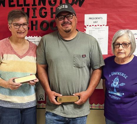 Debbie Scott, left, Larry Molina and Gloria Whitaker garner walnut pen and pencil sets for 20 years of service.