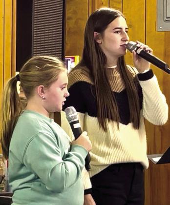 Monson Music Studio students Kinzlee Willis, left, and Saylee Ochoa perform at the Childress Senior Citizens Center luncheon Thursday, Oct. 30, singing five spooky selections just in time for Halloween. Ochoa sang “Spooky, Scary Skeletons,” accompanied by Monson Music Studio owner and instructor Gerald Monson, while Willis sang “The Purple People Eater.” Together, the duo performed “Ghostbusters,” “The Addams Family” and “Witch Doctor.” Courtesy Photo