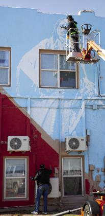 Hall County native Bristen Phillips paints a mural on the north side of Hotel Turkey. their tracks and opened their eyes to wonderful art and the incredible music of Bob Wills. Tumlinson is a nationally recognized muralist with an eye for