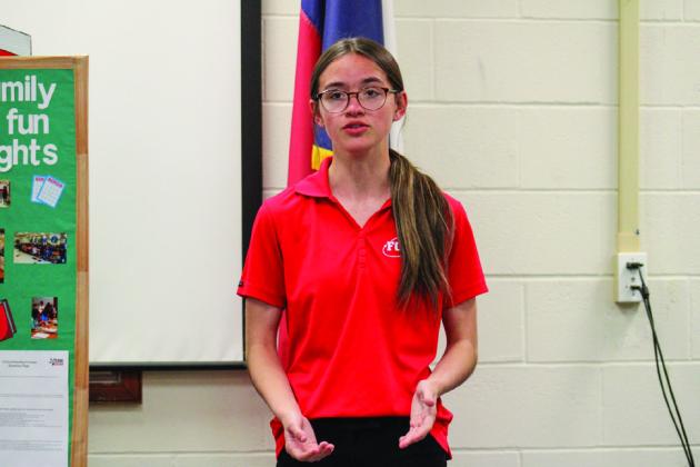 Hailey Holder, along with teammate Samantha Ingram, presents their Focus on Children Level 3 project, “Fostering the Future,” at the Family, Career and Community Leaders of America (FCCLA) Community Night Monday, March 27.