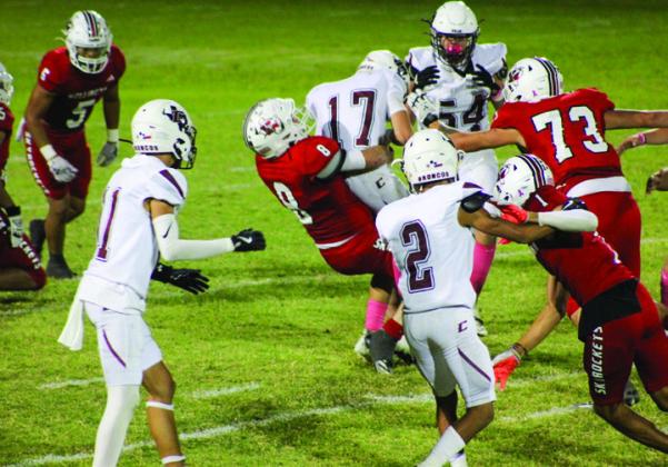 Wellington’s Caleb Strickland (8) takes down Clarendon’s ball carrier, while Brenden Garcia (1), Dalton Holland (73), Miguel Rincon (5), and Yobani Moreno (65) aid on the play.