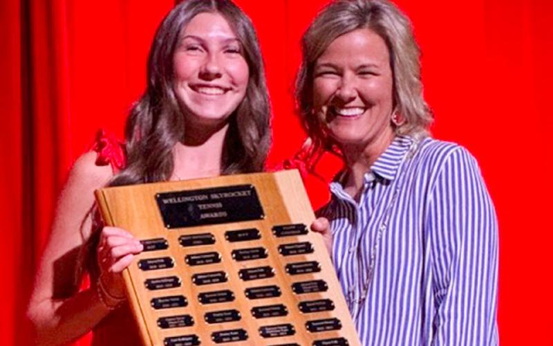 Wellington High School freshman Anna Dwyer receives the Tennis Most Improved Girl Award, presented by Coach Amy Inman. SHAUNA SALINAS/THE GREENBELT INTREPID