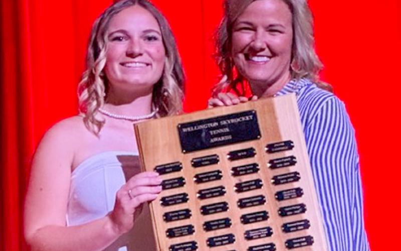 Wellington High School Senior Oakley Folk accepts the Tennis Frank Campbell Award, presented by Coach Amy Inman.