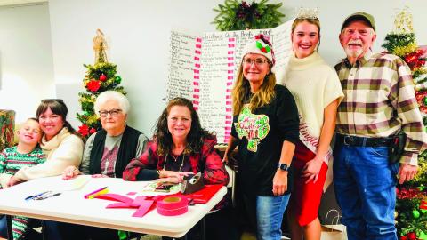 The Collingsworth County Chamber of Commerce Red Ticket Drawing Committee conducts the 2024 drawing at 4:30 p.m. Thursday, Dec. 19 in the Ellis Art Center of the Collingsworth County Museum. From left: Drake and Rachae Barlow, Nancy Harris, Margret Wood, Karen Caldwell, Miss Wellington Maggie Tillman and Billy Wilkerson. The Red River Sun/Bev Odom
