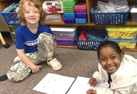 Miss G’s first graders work with a partner to practice reading skills recently. CHILDRESS ELEMENTARY
