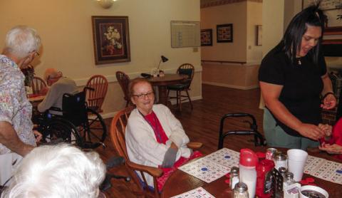 Linda Rothwell has her bingo cards ready for the next game at the weekly bingo session at Cottage Village Assisted Living Facility in Childress. At left, in the foreground, is Frances Weatherlee and Ann Simmers, a regular bingo-time visitor. At right is Cottage Village Caregiver Kimberly Ramos. The number of weekly games played depends on how many the residents request, said number caller Anne Fromm.