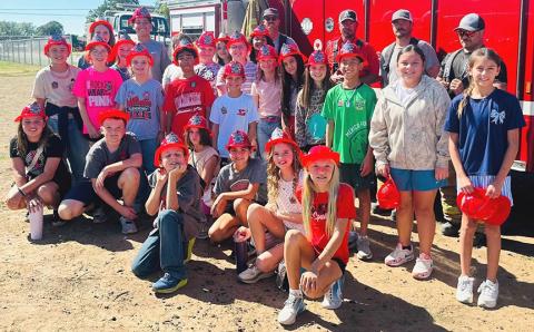 STOP, DROP, and ROLL emphasized Wellington Volunteer Fire Department visitors for Fire Prevention Week on Oct. 7. Packed with important fire safety lessons, big smiles, and local heroes, Sparklers listened carefully and practiced their survival skills. Firemen and their Sparklers embraced getting to spend time together for such a worthy cause. Shown here: Fifth Grade Sparklers WELLINGTON ELEMENTARY SCHOOL { (