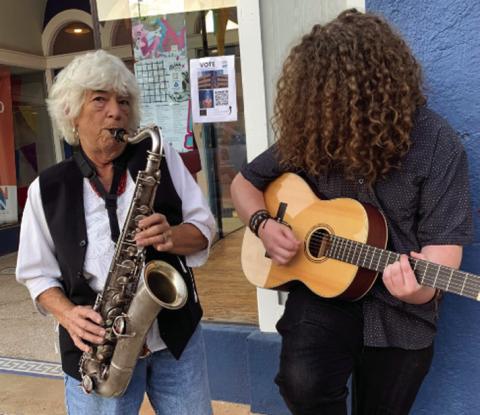 Photo by Terri Drake Hanaba Munn Welch blows some sidewalk notes to Walter Anderson’s punk riffs during the October After Hours Artwalk in Wichita Falls.