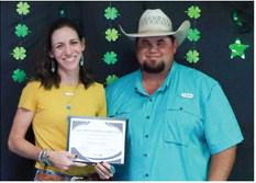 Texas A&amp;M AgriLife Extension Service of Collingsworth County Ag and Natural Resources Agent Kenny Patterson, right, presents Molly Sims the 2023-2024 Distinguished Leader merit.