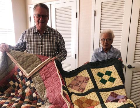 Neal Odom assists Odessa Covey in displaying two quilts, made by Covey, which will be auctioned during the Wellington Methodist Women’s Fall Bazaar at 12:30 p.m. Saturday, Nov. 5. The Red River Sun/Bev Odom
