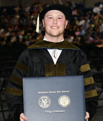 Cory Bodine, of Quanah, accepts his Doctor of Pharmacy Degree from Southwestern Oklahoma State University.
