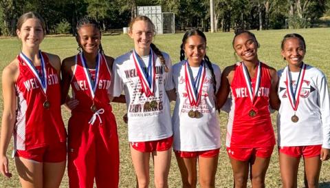 Wellington High School sophomore Taytum Kane claimed the district cross country championship, setting a new personal record of 12:07.49, at the District 2-2A Cross Country Championship Wednesday, Oct. 8 in Wheeler. From left: Anna Henard, Angela Lewis, Taytum Kane, Sabrina Segovia, Aleah Lewis, Kobee Lewis. 