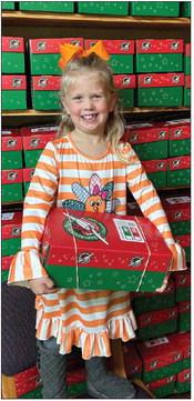 Kellyn Conner, daughter of Jordan and Tucker Conner, helped her grandmother, Wendy Langford, and Rosa Carter pack 50 shoeboxes for delivery to impoverished children around the globe through Samaritan’s Purse Operation Christmas Child ministry. Courtesy Photo