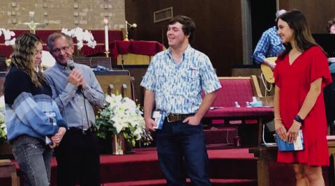 First Methodist Church Pastor Gene Weinette questions members of the Wellington High School Class of 2025 concerning their future plans during the Sunday morning, April 27 worship service. After he presented each with a Bible, he offered the young adults a bit of advice concerning skipping class. From left, Kenzi Ballinger, Weinette, Caleb Strickland and Emma Flores. The Red River Sun/Bev Odom