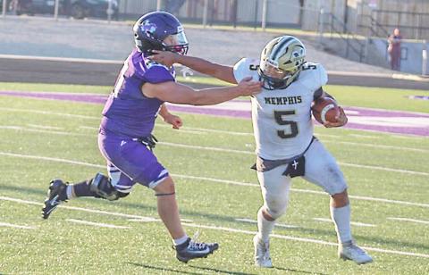 A Memphis Cyclone tries to fend off a Benjamin defense player last week during the six-man season opener. Memphis will face Follett Sept. 4 and then Vernon JV on Sept. 9, both games will be on the road.