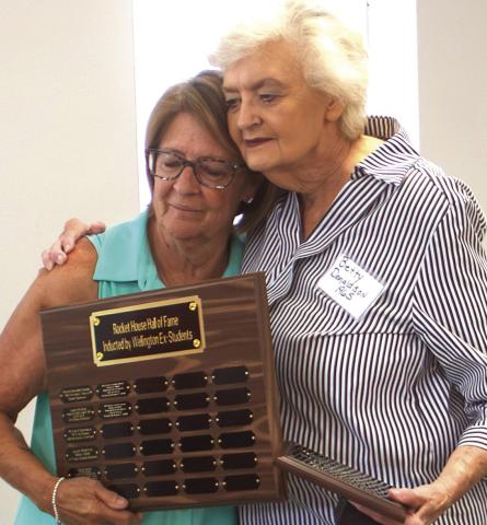 Betty Courtney Donaldson, Wellington High School Class of 1965, embraces Renee Hanna as she is named a 2026 Rocket House Hall of Fame inductee. HZW MEDIA PHOTO