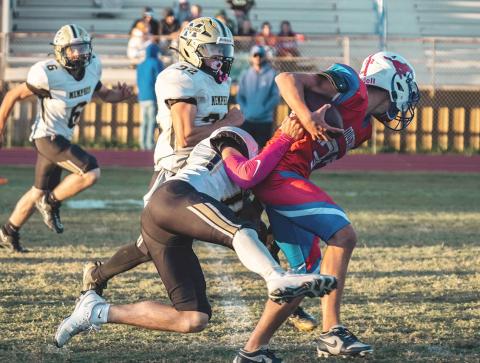 A Cyclone football player takes down a JV Claude Mustang last week during Memphis’ victory. PECOS BALLARD PHOTOGRAPHY