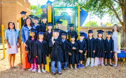 Suited in caps and gowns, the Austin Elementary School Class of 2029 waves goodbye to kindergarten. KKR PHOTOGRAPHY