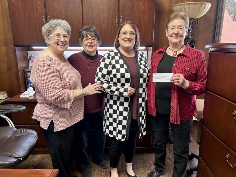 Modern Home Club representatives present a check to Childress Helping Hands’ Kacy Crouch. Courtesy Photo