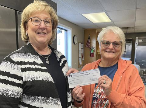 Memphis Country Club Board Member Kelli Little presents a check for $500 to Hall County Home Delivered Meals Director Kila Manuel. The money was the proceeds from the Memphis Country Club’s Poker Run held during Hall County Picnic last month. INTREPID PHOTO / CINDY WOODARD