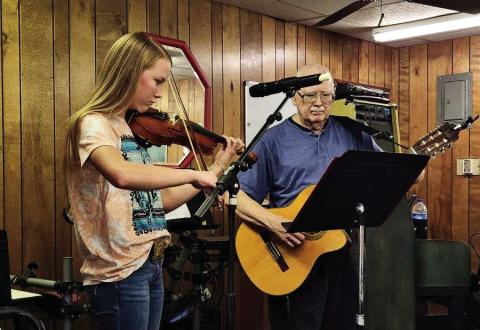 Monson Music Studio’s RayLee Elliot, the 13-yearold daughter of Shawn and Shaley Elliot, plays the violin while singing the verses of three songs, including “Faded Love” by Bob Wills, “Tennessee Waltz” by Patti Page and “Let’s Go Riding on a Cloud,” at a recent Childress Senior Citizens Center luncheon. Accompanying her on guitar was Monson Music Studio instructor Gerald Monson. Courtesy Photo
