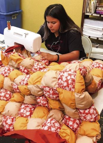 Collingsworth County 4-H member Cecilia Granadoz completes the corner of her 2022 puff quilt project under the guidance of Collingsworth County Extension Program Assistant Tammy Rodriguez and volunteer Phyllis Floyd. Courtesy Photos