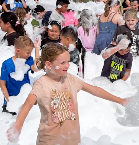 Summer readers frolic in library’s foam party