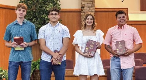 Members of the Wellington High School Class of 2024 receive recognition Sunday, May 5 during the morning worship service at First Baptist Church. Each student received a bible, presented by Kelli Killian. From left: Nixon Folk, Ethan Nevarez, Summer Neufeld, Tryston O’Rear. Courtesy Photo