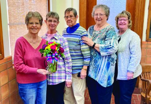 Modern Home Club member Margie Porter, left, wins the drawing for a floral centerpiece, provided by Catherines. From left: Porter, Linda Gooch, Ramona Garcia, Rosemary Foster and Sandra Moody. Modern Home Club