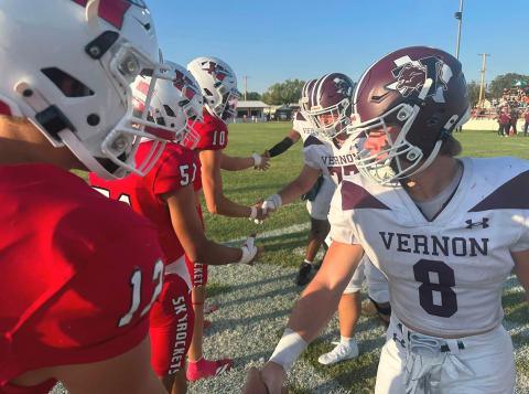 Wellington team captains for the week, Callen Kane (12), King Molina (51), Jake Chandler (10) and Hunter Hedrick (52), not pictured, meet up with the Vernon Lions team captains before the game last Friday, Sept. 4 on Powell Field. PHOTO BY RUBEN ON THE ROAD