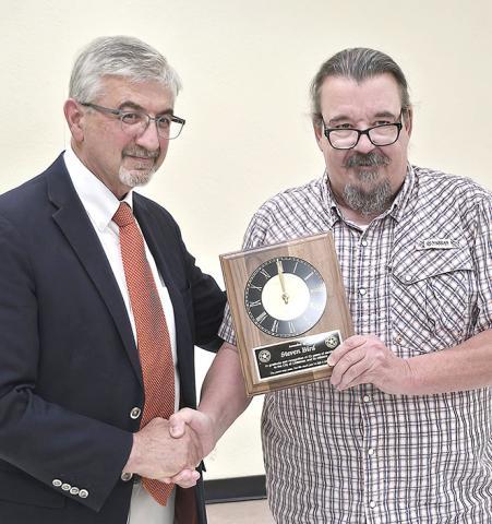 Childress City Attorney Steven Bird (left) receives a plaque from Mayor Cary Preston recognizing his longtime service to the city during a called council meeting Monday night. Bird has served as the city’s attorney for 42 years. The council selected Underwood Law Firm to be the city’s new legal counsel.