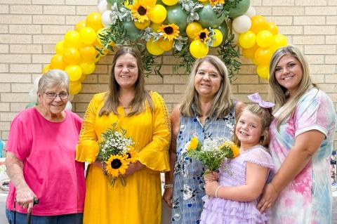 Grandmother Carole Meeks, left, guest of honor Jaci Roberson, mother Verna Wagner, niece Shayli Wagner and twin sister Joni Wagner gather amongst the gifts during the Saturday, Aug. 9 baby shower festivities. Courtesy Photo