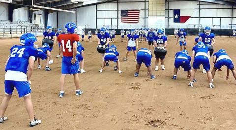 When the new Wet Bulb Globe Temperature guidelines tried to cancel practice, the Childress Bobcats improvised, trading the football field for the indoor rodeo arena, Thursday, Aug. 13. COURTESY PHOTO/ JUSTIN HASTINGS