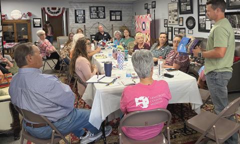 Explore West Texas Publisher Ramon Johnston, of Lubbock, displays the Fall 2026 issue featuring San Angelo Museum of Fine Arts on the back cover where Panhandle Area Museum Directors gathered Monday, Sept. 14, at the Collingsworth County Museum. INTREPID PHOTO / BEV ODOM
