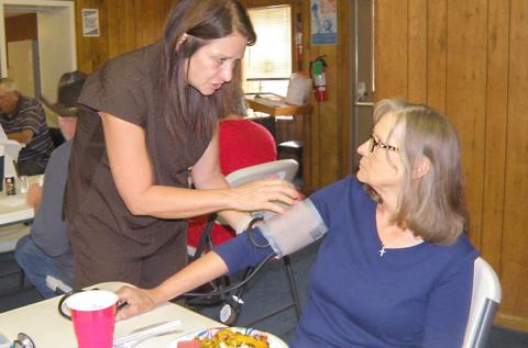 Visiting nurse gives blood pressure checks