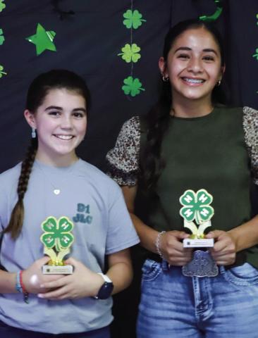 Quinn Roberson, left, accepts the Junior Gold Accomplishment Award, while Hazel Estrada receives the Intermediate Gold Accomplishment Award.